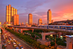 The Bangkok Skytrain at sunset on Thanon Narathiwat Ratcha Nakharin with Empire Tower at the back.