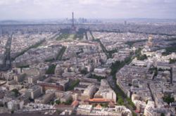 View from the Montparnasse Tower (Tour Montparnasse) towards the Eiffel Tower. On the right Napoleon's tomb lies under the golden dome at Les Invalides. The towers of the office and entertainment centre La Défense are on the horizon.