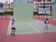 Two men playing Paleta Fronton in Lima, Peru