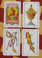 The four aces present in the baraja, from the deck made by Heraclio Fournier. Left to right, top to bottom: oros, copas, espadas and bastos.