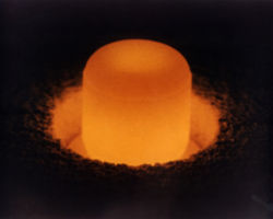 A pellet of plutonium-238, glowing under its own light, used for radioisotope thermoelectric generators.