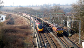 An intercity passenger train (left) and freight train (right) in Great Britain