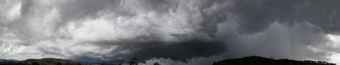 A panorama showing relatively clear skies on the left and a rain cloud on the right