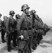 The National Revolutionary Army were trained troops standing at attention during an inspection by German officers during Second Sino-Japanese War.