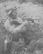 A soldier fully decked in German equipment - Stahlhelm, gas mask, and Mauser pistol