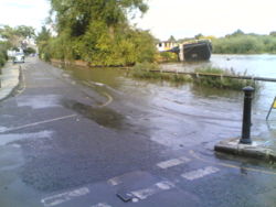 The River Thames flooding at Chiswick Lane South in London's W4 postal district.