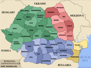 Administrative map of Romania outlining the forty-one counties. The map also shows the historical region of Transylvania in green, Wallachia in blue, Moldavia in red, and Dobrogea in yellow.