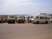 A row of minibus share taxis waiting to depart in Kigali.