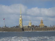 The golden spire of the Peter and Paul Cathedral rises above the Peter and Paul Fortress on the Neva river
