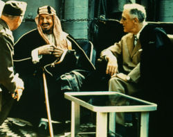 The founder of modern Saudi Arabia, King Abdul Aziz, converses with President Franklin Delano Roosevelt on board a ship returning from the Yalta Conference in 1945.