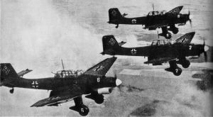 A flight of Stuka dive-bombers prepares to attack.