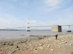 The Severn Bridge seen from the English side of the river.  From 1966 to 1996, the bridge carried the M4 motorway. On completion of the Second Severn crossing the motorway from Aust on the English side to Rogiet was renamed the M48