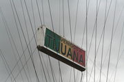 From the arch hands a sign saying "Bienvenidos a Tijuana" (Welcome to Tijuana)