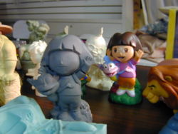 Dora the Explorer sculpture, and the finished toy based on it.