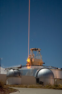 A FASOR used at the Starfire Optical Range for LIDAR and laser guide star experiments is tuned to the sodium D2a line and used to excite sodium atoms in the upper atmosphere.  FASOR stands for Frequency Addition Source of Optical Radiation, and for this system it is two single mode and single frequency solid state IR lasers, 1.064 and 1.319 microns, that are frequency summed in a LBO crystal within a doubly resonant cavity.
