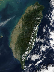 The terrain of Taiwan is mostly mountainous in the east but gradually changes to gently sloping plains in the west. Penghu Islands (the Pescadores) are to the west of Taiwan (Satellite photo by NASA).