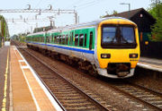 An electric multiple unit pulling into Tile Hill station; Coventry, England