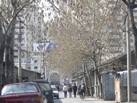 A Hutong （胡同） in eastern urban Beijing near Dongsishitiao. When photographed in March 2003, the left side was still standing; it has since given way to a new construction project.