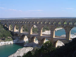 Pont du Gard in France is a Roman aqueduct built in ca. 19 BC. It is one of France's top tourist attractions and a World Heritage Site.