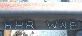 In 2004, initials of VGN founders Henry Huttleston Rogers and William Nelson Page were engraved by volunteers in newly laid rail at Victoria, Virginia, where former VGN caboose #342 is now displayed. Virginian Railway Cabooses photo by Tom Salmon, courtesy of Virginian Railway Enthusiasts on Yahoo