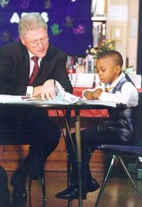 Clinton reading with a child.