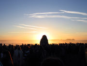 The Sun rising behind the Heel Stone at Stonehenge