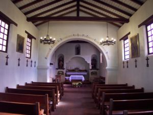 A look inside the reconstructed (half-size) chapel at Mission Santa Cruz in December 2004. Note the exposed wood beams that comprise the roof structure.