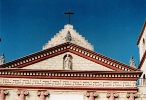 A close-up view of the pediment situated above the chapel entrance at Mission Santa Barbara and its unique ornamental frieze.