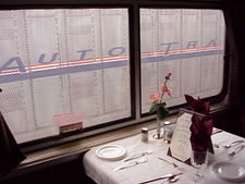 An Auto Train dining car awaits passengers next to an auto carrier which will join it at the rear of the consist.