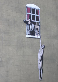 Naked Man image by Banksy, in Park Street, Bristol, England. Following popular support, the City Council have decided it will be allowed to remain - (wider view).