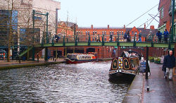 The Birmingham Canal Navigations between the International Convention Centre (left) and Brindleyplace (right) in central Birmingham.