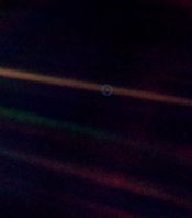 Earth seen as a tiny dot by the Voyager 1 spacecraft, four billion miles from Earth