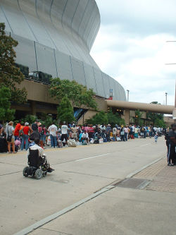 Displaced people bringing their belongings and lining up to get into the Superdome.
