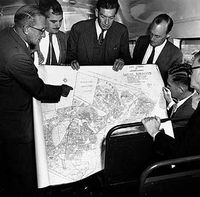 The original architects of apartheid gathered around a map of a planned township.