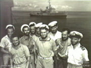 Australian sailors with a Bathurst Class corvette in the background. The RAN commissioned 56 of this class of corvettes during World War II.