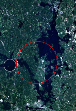 Landsat 7 image of the Keurusselkä region. Area where shatter cones have been found is marked with a red ellipse and the suggested impact structure of Ukonselkä is marked with a white circle.