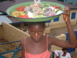 A girl sells produce in Logba