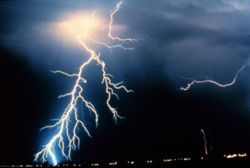 Lightning strikes during a night-time thunderstorm. Energy is radiated as light when powerful electric currents flow through the Earth's atmosphere.