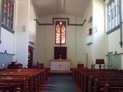 Inside St Mary the Virgin Church in South Perth. View is from the entrance towards the altar, note that the Stain glass windows are only on the northern side of the church