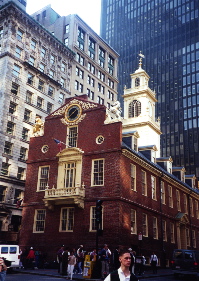 The 18th century Old State House in Boston is surrounded by tall buildings of the 19th and 20th centuries.