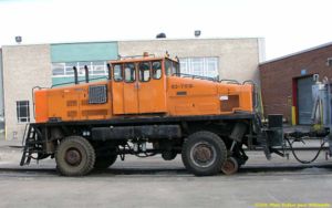 Heavy work trains are hauled with sizeable tractors such as this old (1966) “Duplex”. Traction is effected through the rubber-tyred wheels, and guidance through the retractable flanged wheel. This tractor can also operate on the road.