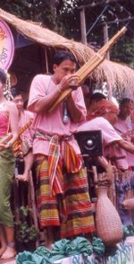 Khene player wearing sarong and pakama at the Ubon Candle Festival
