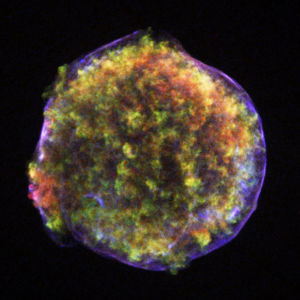 The remnant of Tycho's Supernova, a huge ball of expanding plasma. The blue outer shell arises from X-ray emission by high-speed electrons.