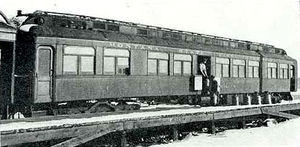 The Thymallus, a "fish car" of the Montana State Fish Service, circa 1910.  The attendants are loading stainless steel milk cans filled with fish onto the car.