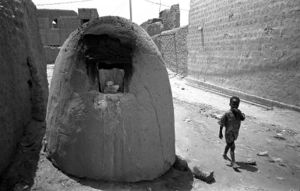 A typical street scene of Timbuktu, Mali, with omnipresent bread-baking furnaces 