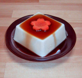 Silken tofu with soy sauce and a decorative carrot slice