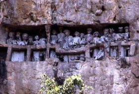 A stone carved burial site. Tau tau (effigies of the deceased) were put in the cave, facing down the land.