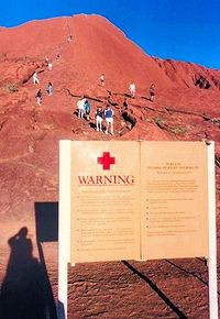 Climbers and warning sign