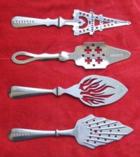 Collection of absinthe spoons. These specialized spoons were used to hold the sugar cube over which ice-cold water was poured to dilute the absinthe. Note the slot on the handle that allows the spoon to rest on the brim of the glass.