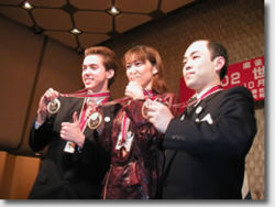 The top three of the World Championship in Mahjong, Tokyo, October 2002. In the middle: world champion Mai Hatsune from Japan.